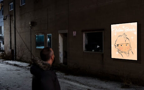 Person looking at the lightbox with a portrayal of Anishinaabe children by artist Shemia Nelson